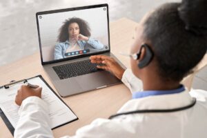 virtual doctor talks to a woman on a laptop