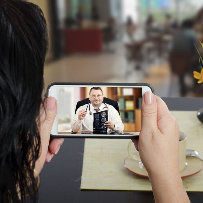 a person holding a phone to a man's face