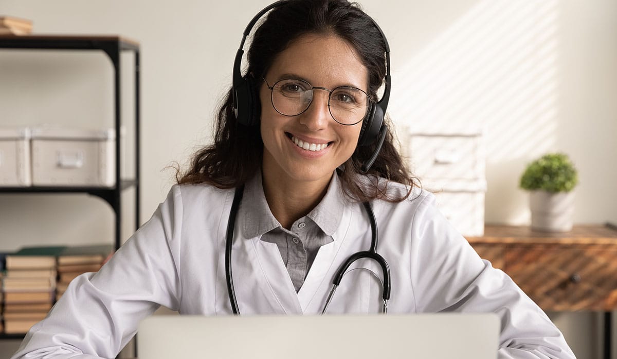 a woman wearing headphones and a white coat