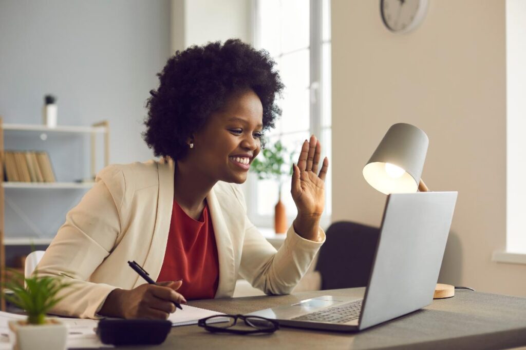 woman smiling into laptop talking about expert second opinions