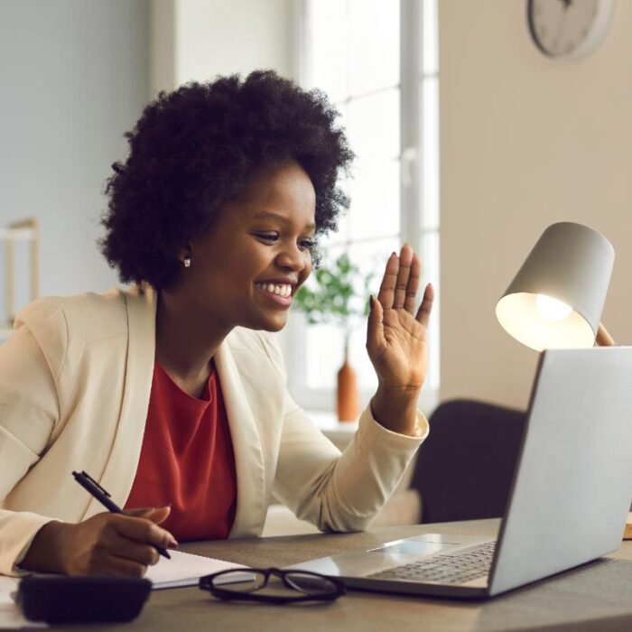 woman smiling into laptop talking about expert second opinions