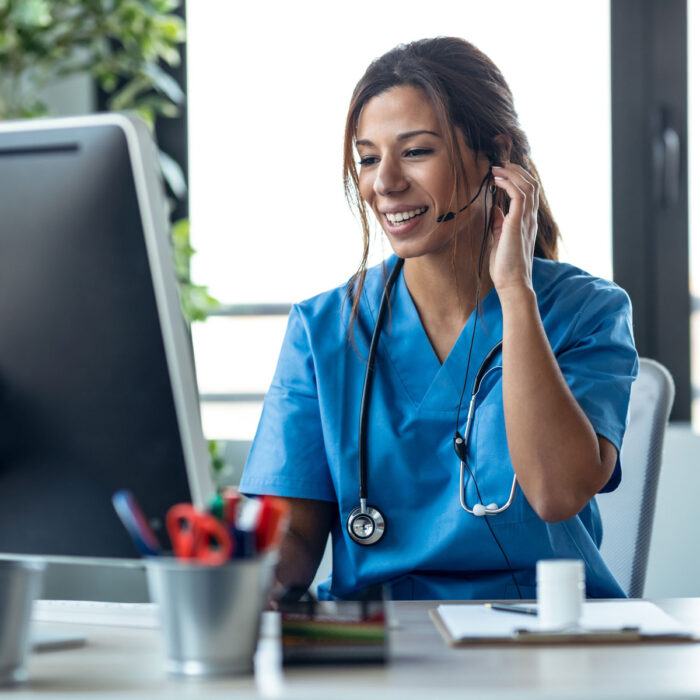 a woman wearing a blue scrubs and a headset