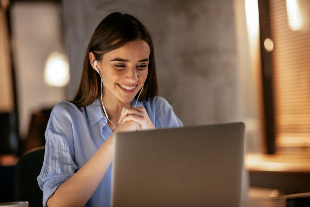 woman in blue shirt looks at laptop while learning about employee second opinion programs