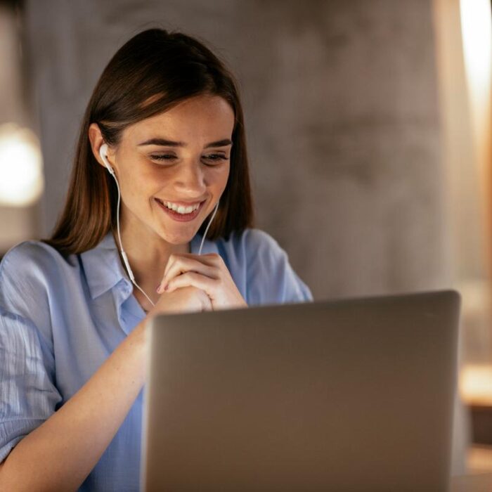 woman in blue shirt looks at laptop while learning about employee second opinion programs