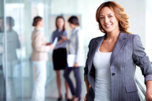 woman in blazer with colleagues talking about how to improve employee health