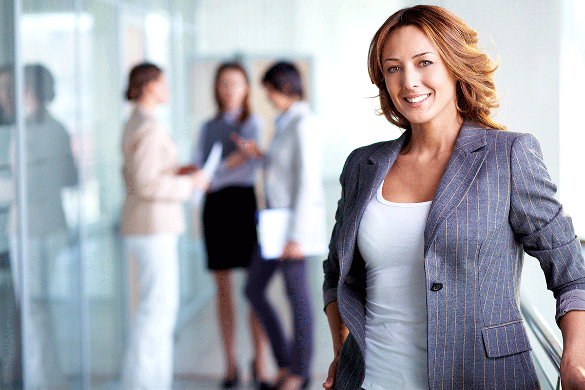woman in blazer with colleagues talking about how to improve employee health