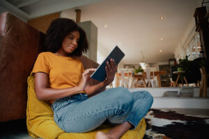 woman in orange shirt looking at tablet and learning what a second opinion is