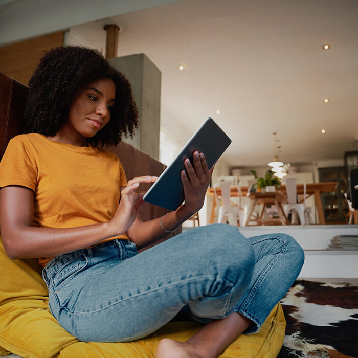 woman in orange shirt looking at tablet and learning what a second opinion is