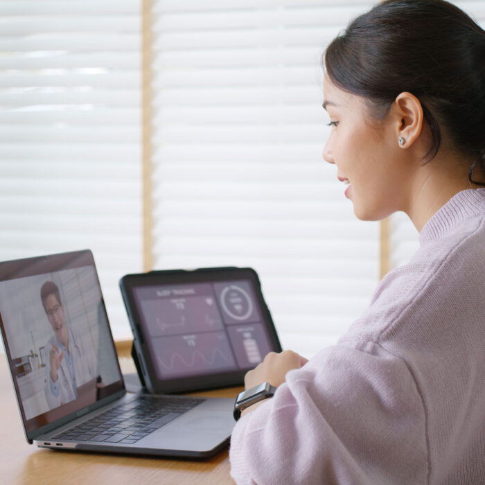 a woman looking at a laptop