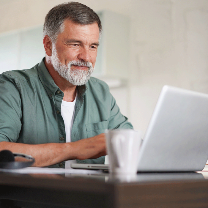 man looking at laptop while learning about how often second opinions are different