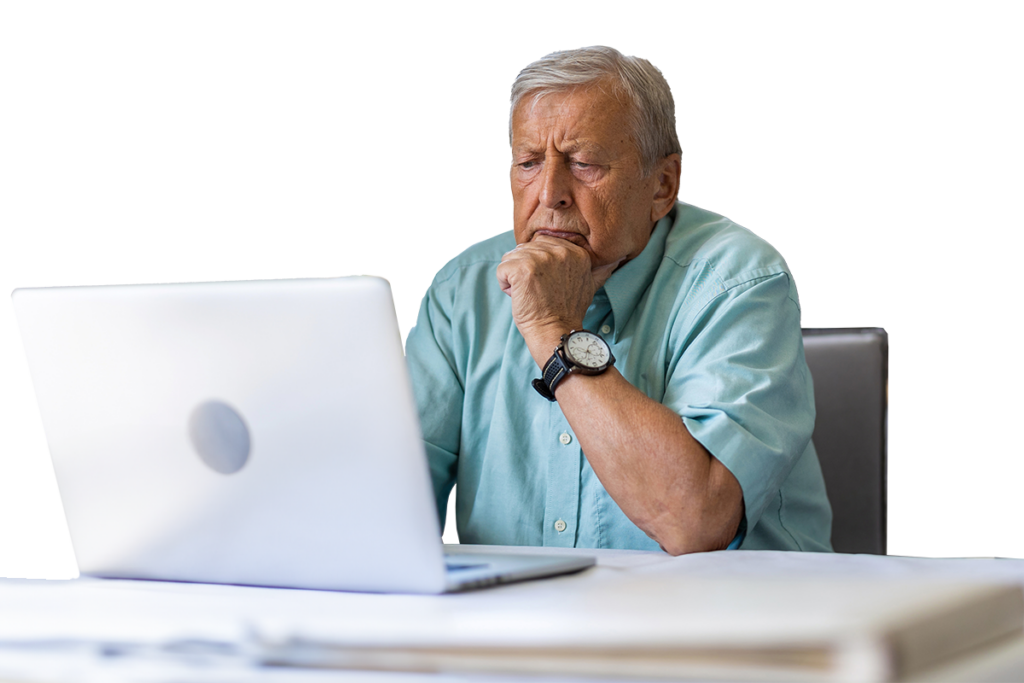a man sitting at a table with his hand on his chin