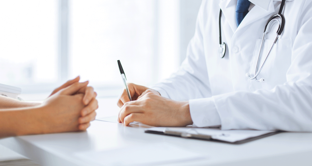 a doctor writing on a paper