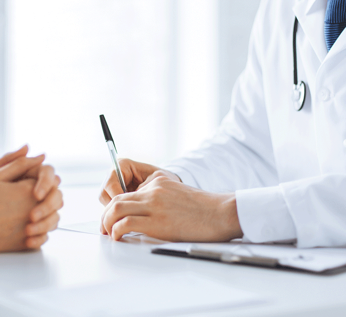 a doctor talks with a patient about Barriers to Getting a Second Medical Opinion