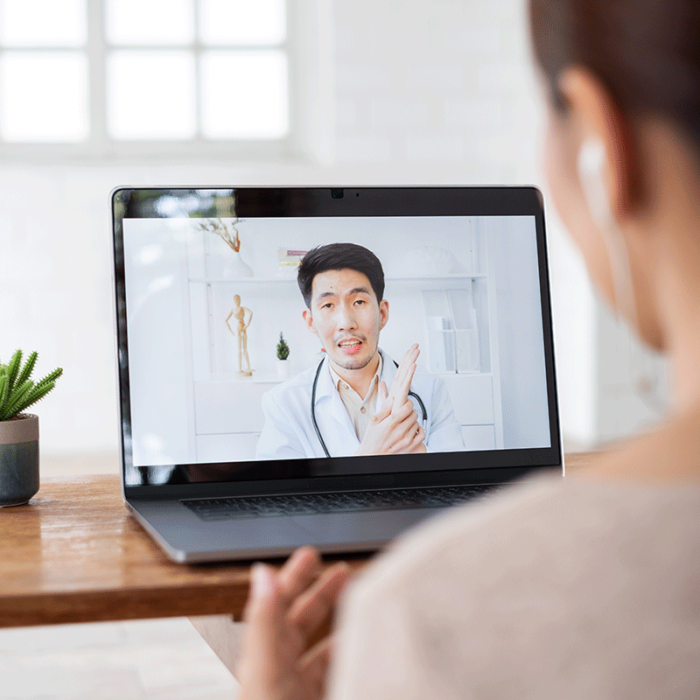a woman looking at a laptop screen