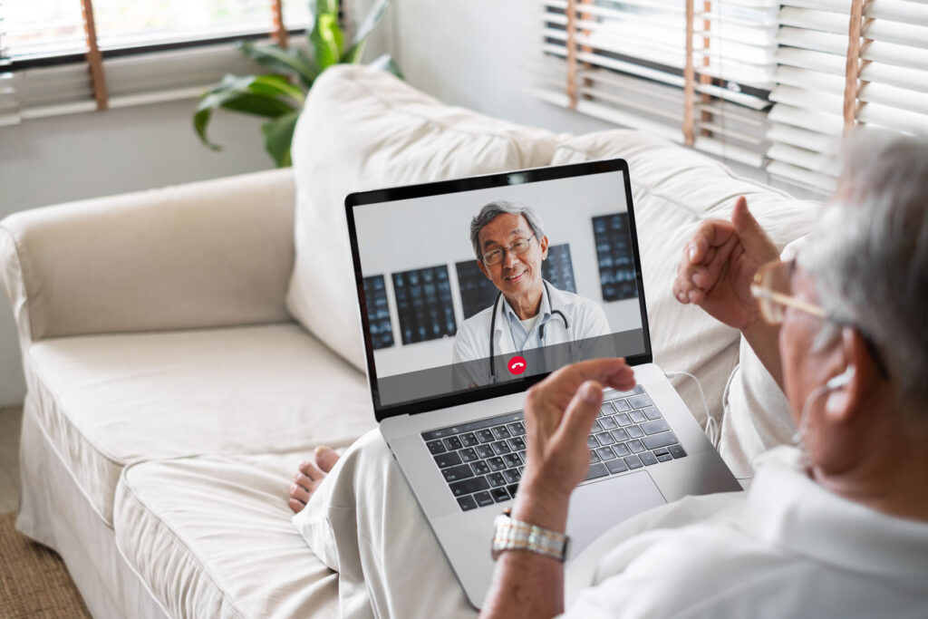 a man sitting on a couch with a laptop