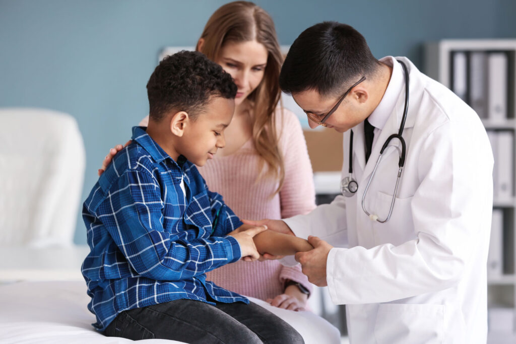 A parent seeks a pediatric second opinion for her little boy. He is being examined by a physician.