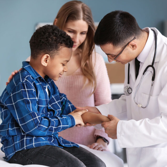 A parent seeks a pediatric second opinion for her little boy. He is being examined by a physician.